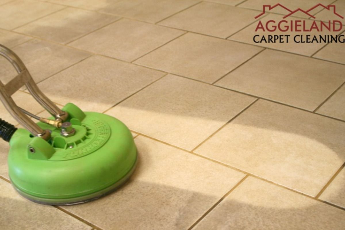 a green carpet cleaner is being used on a tiled floor