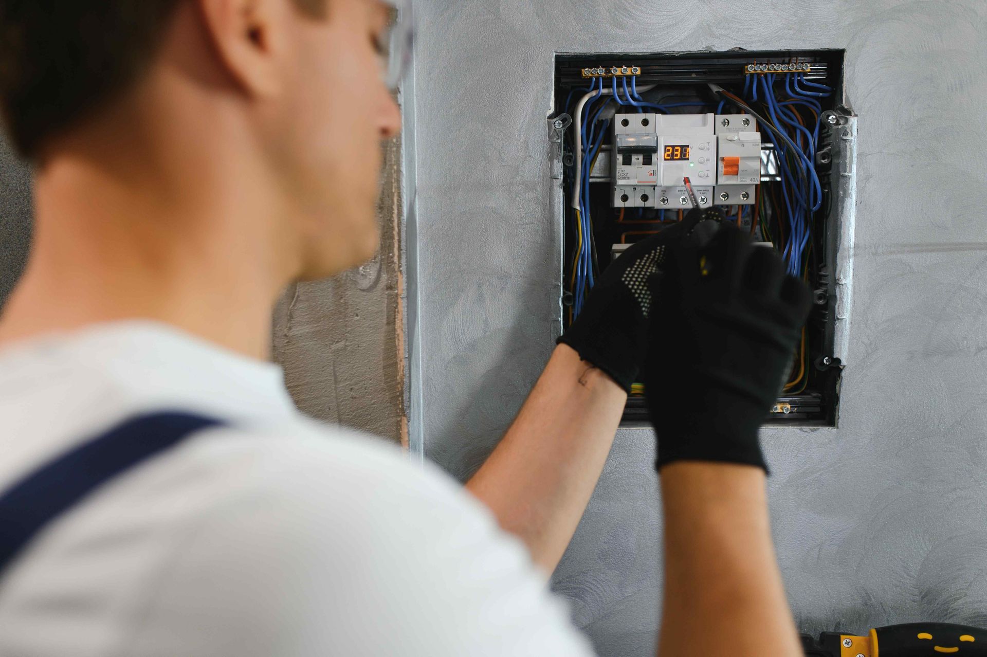 Affordable Electrician Working On Electrical Panel In Home