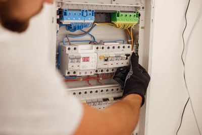 Electrician Working With Fuses in Affordable Upgraded Electrical Panel That Was Installed