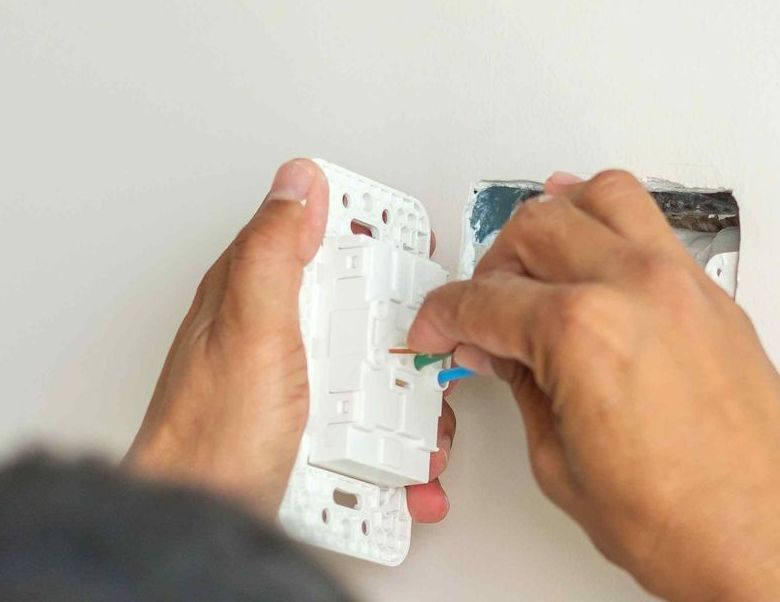 Electrician Installing Wire Cables For Electrical Outlet