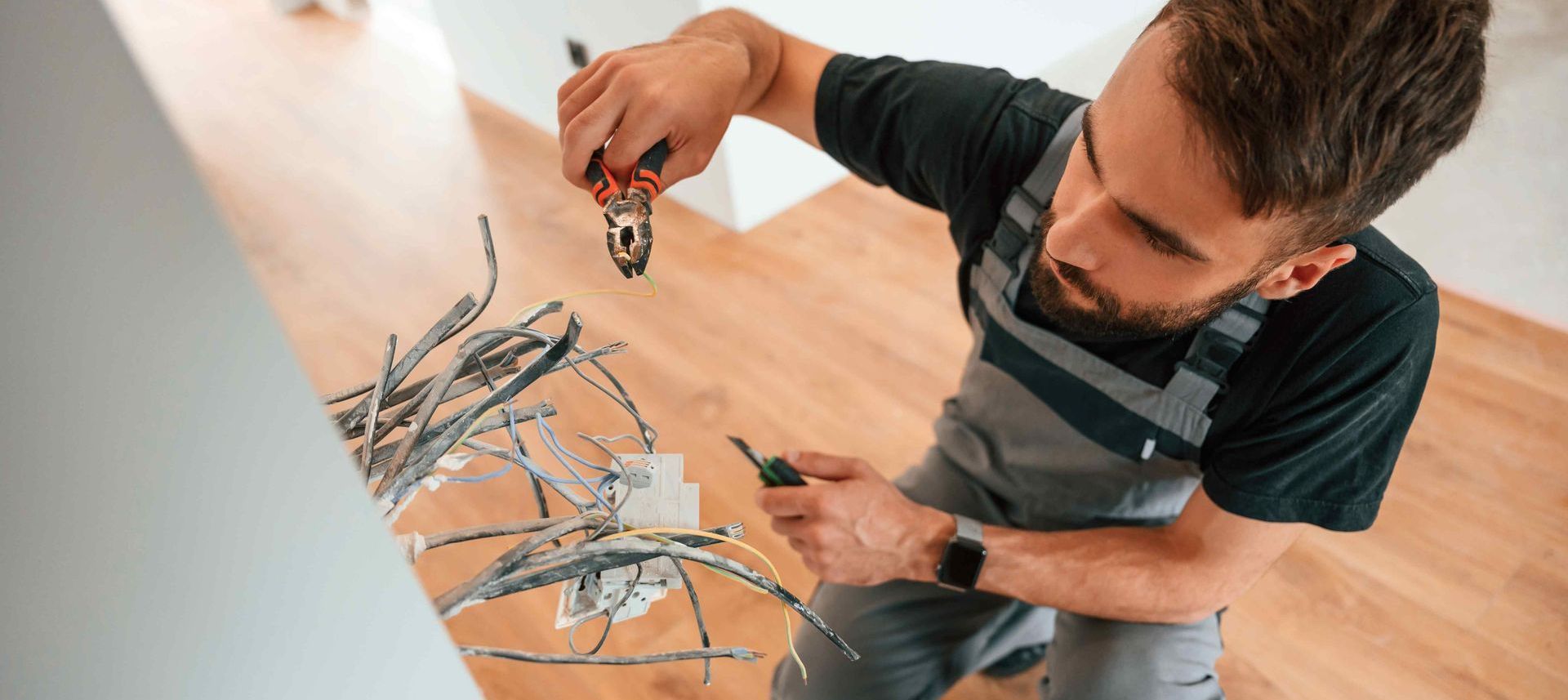 Professional Electrician Rewiring Home To Fix Electrical Hot Spot
