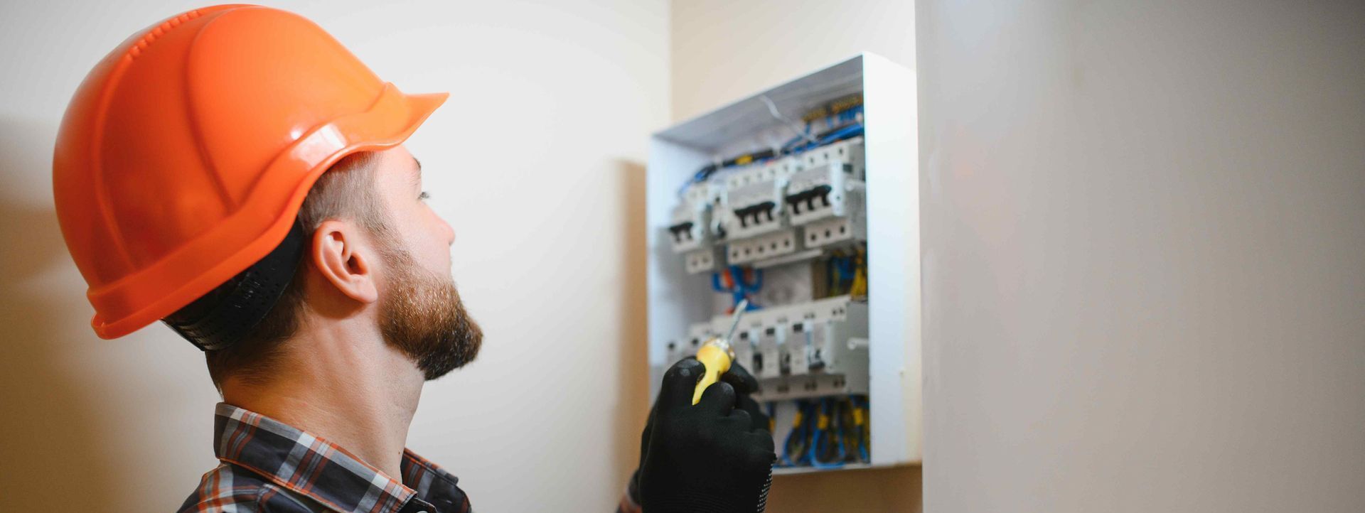 Electrician Works On Switchboard In Small Business