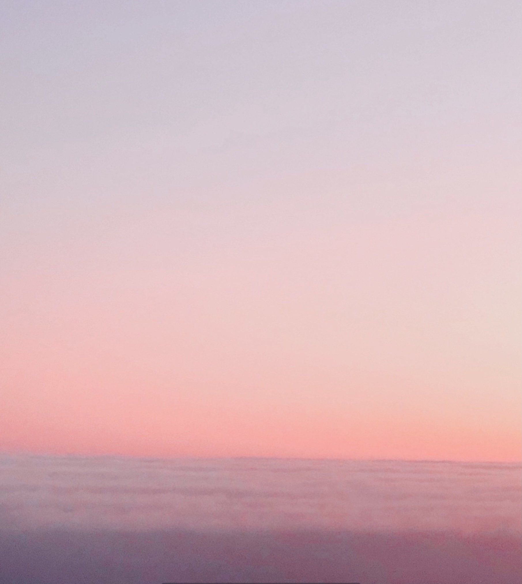 A pink and purple sunset over a body of water