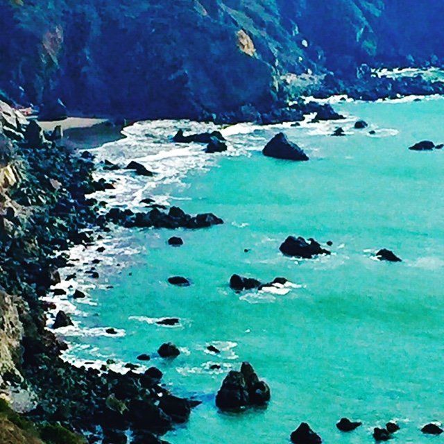 A large body of water surrounded by rocks and cliffs