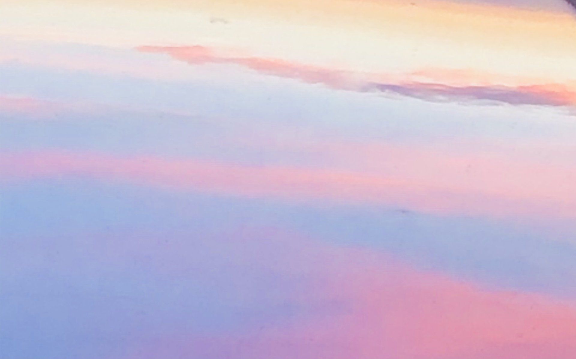 A pink and purple sunset with clouds in the sky
