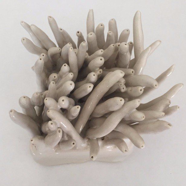 A close up of a ceramic coral sculpture on a white surface