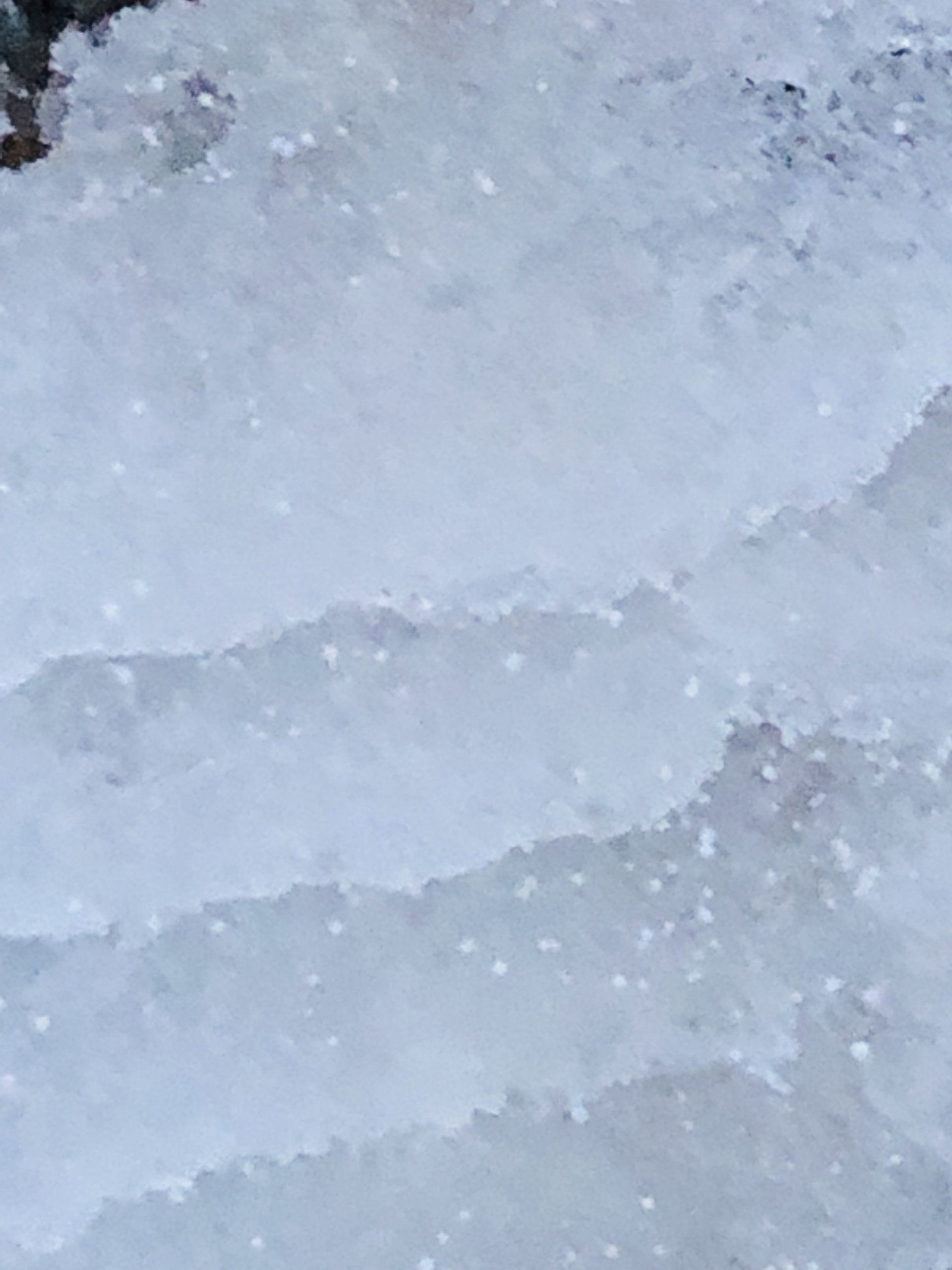 A close up of a pile of snow on the ground.