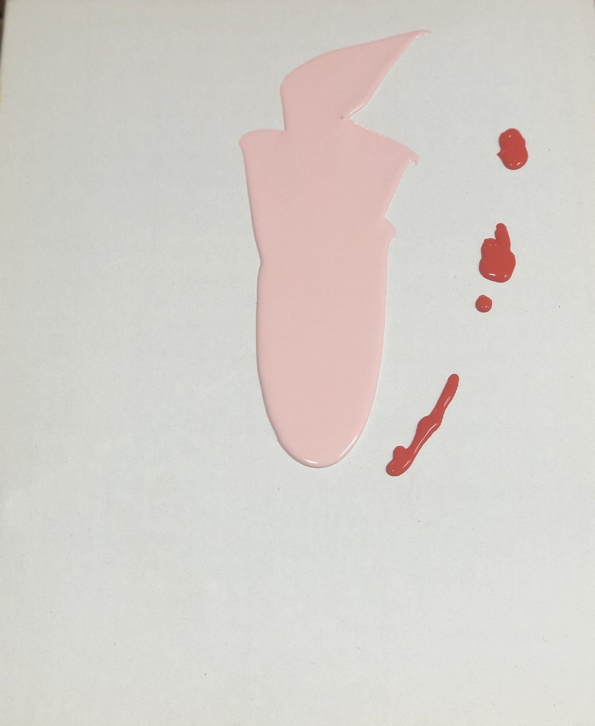 A white surface with a pink silhouette and red spots