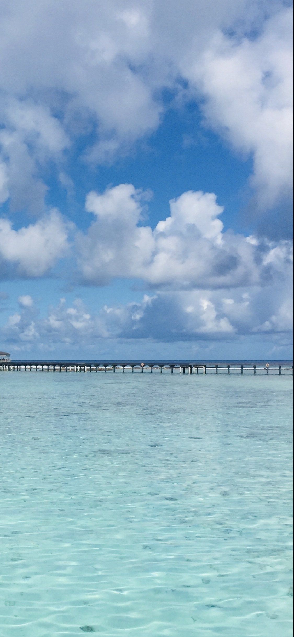 A pier in the middle of a body of water