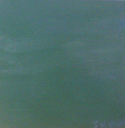 A close up of a green tile that looks like a chalkboard.