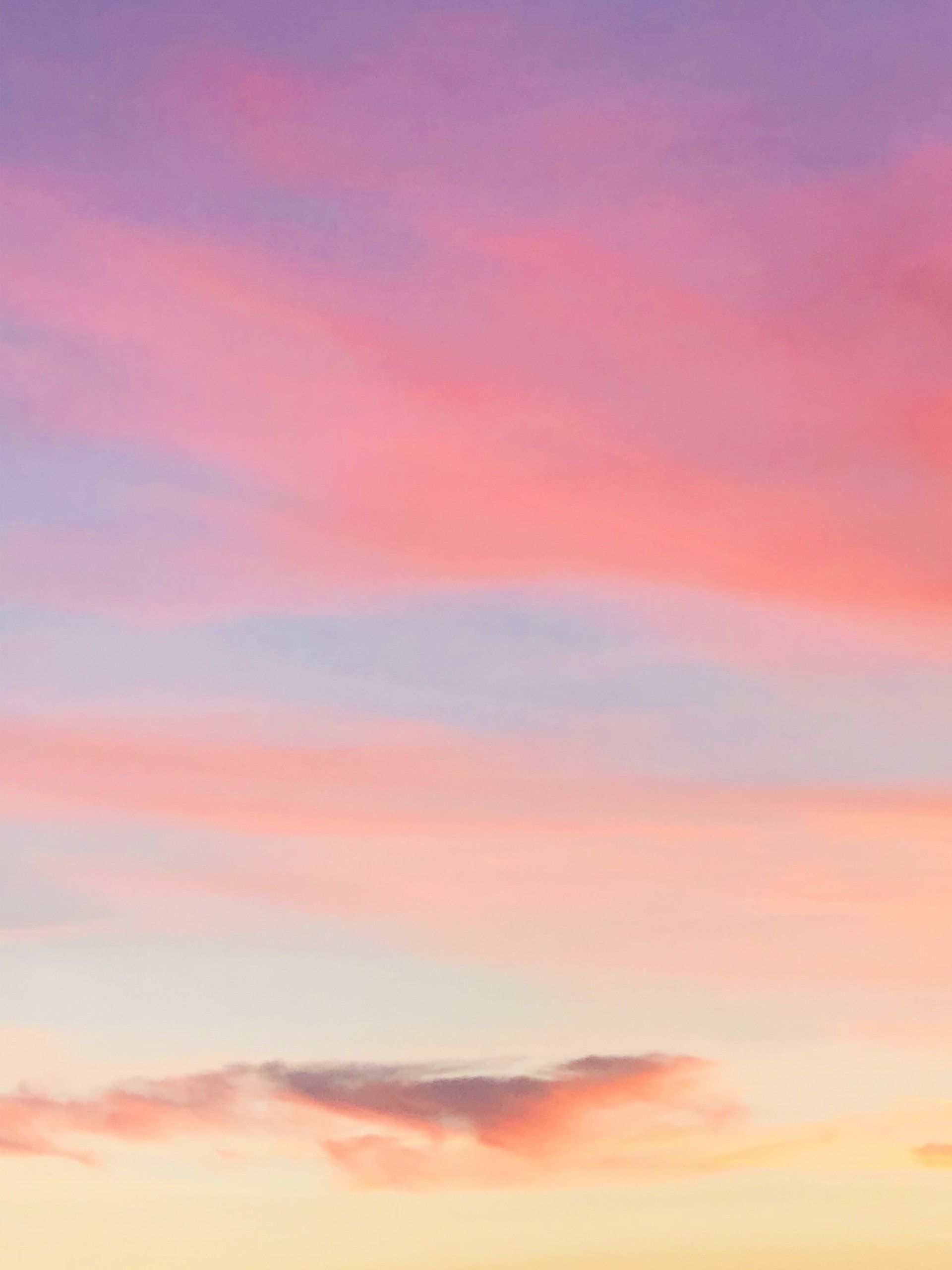A colorful sunset sky with a few clouds in it