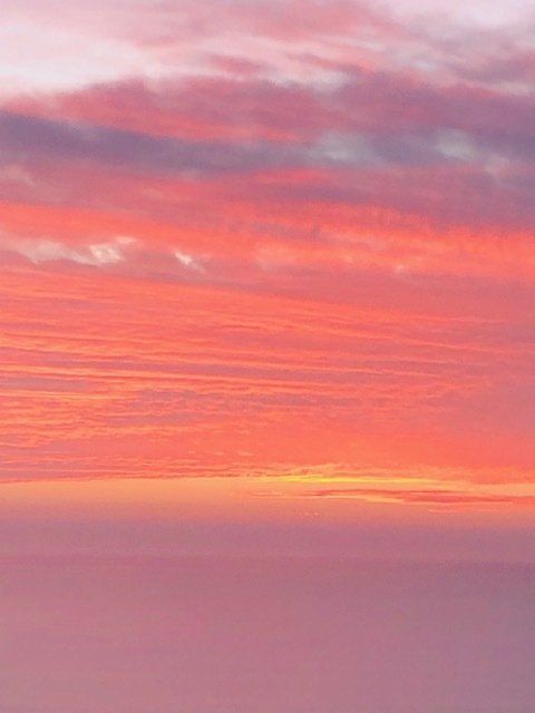 A sunset with pink and orange clouds in the sky