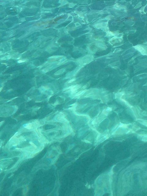 A close up of a turquoise water surface in a swimming pool.