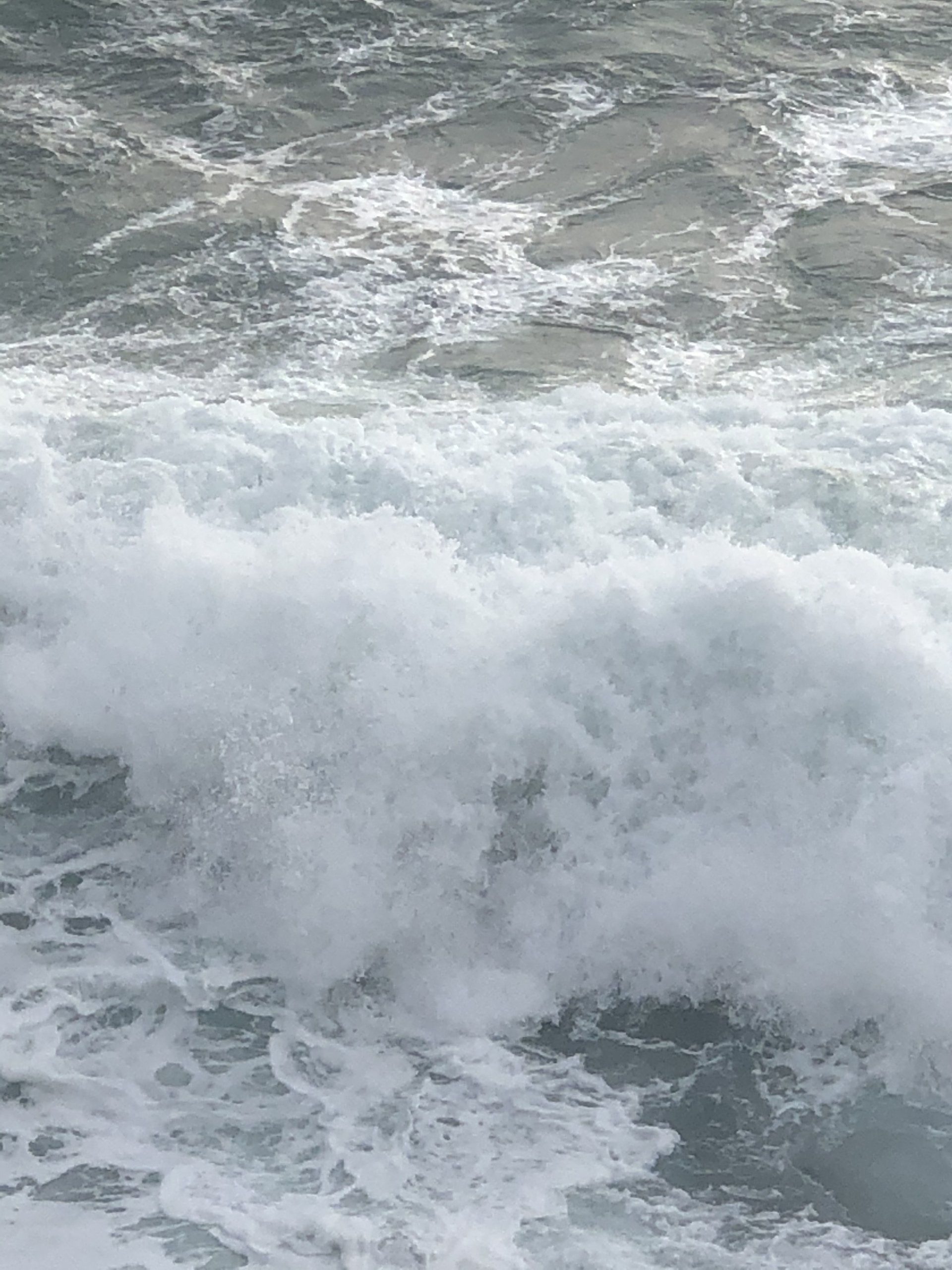 A close up of a large wave in the ocean.