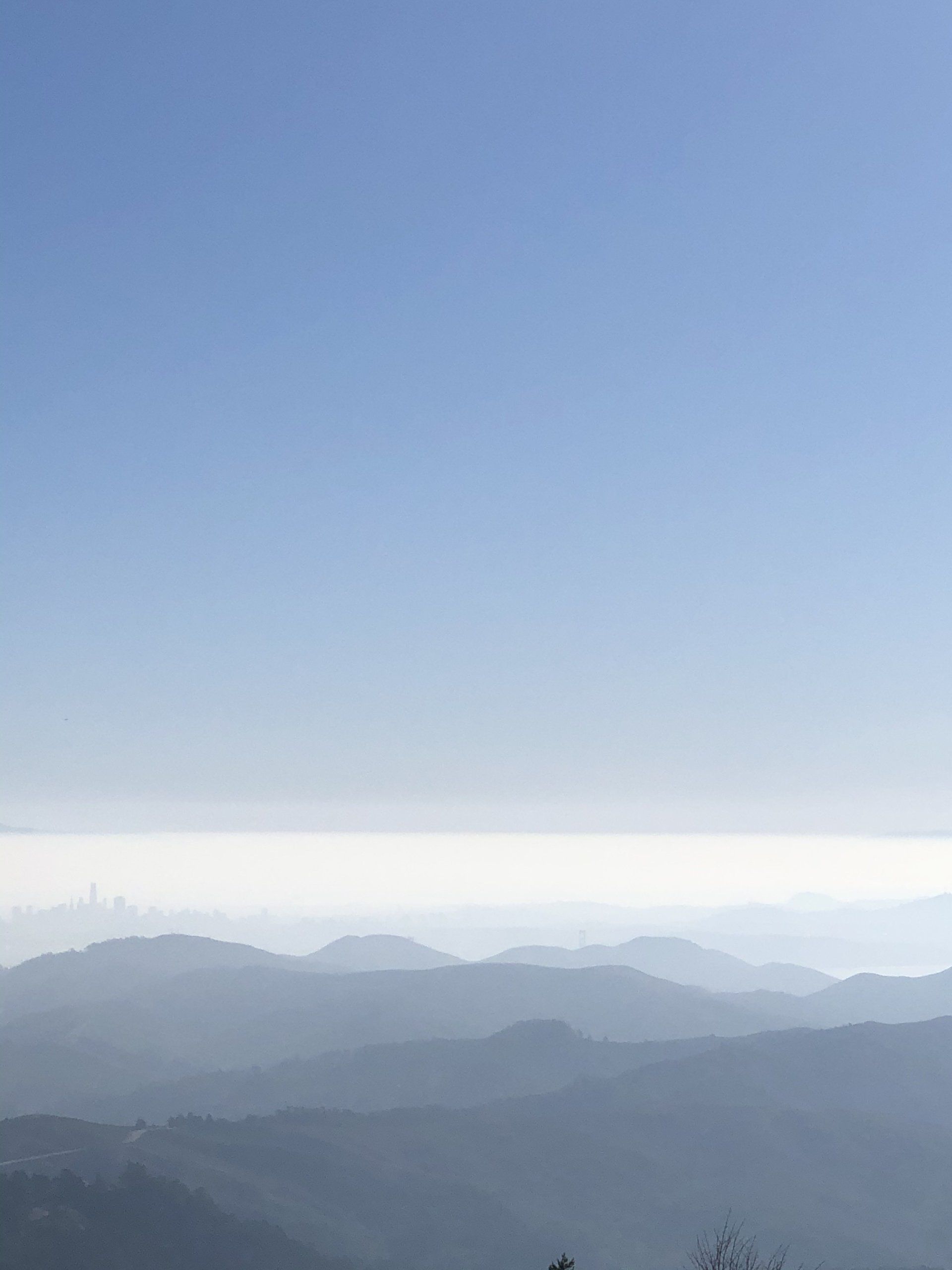 A view of a mountain range with a blue sky in the background.