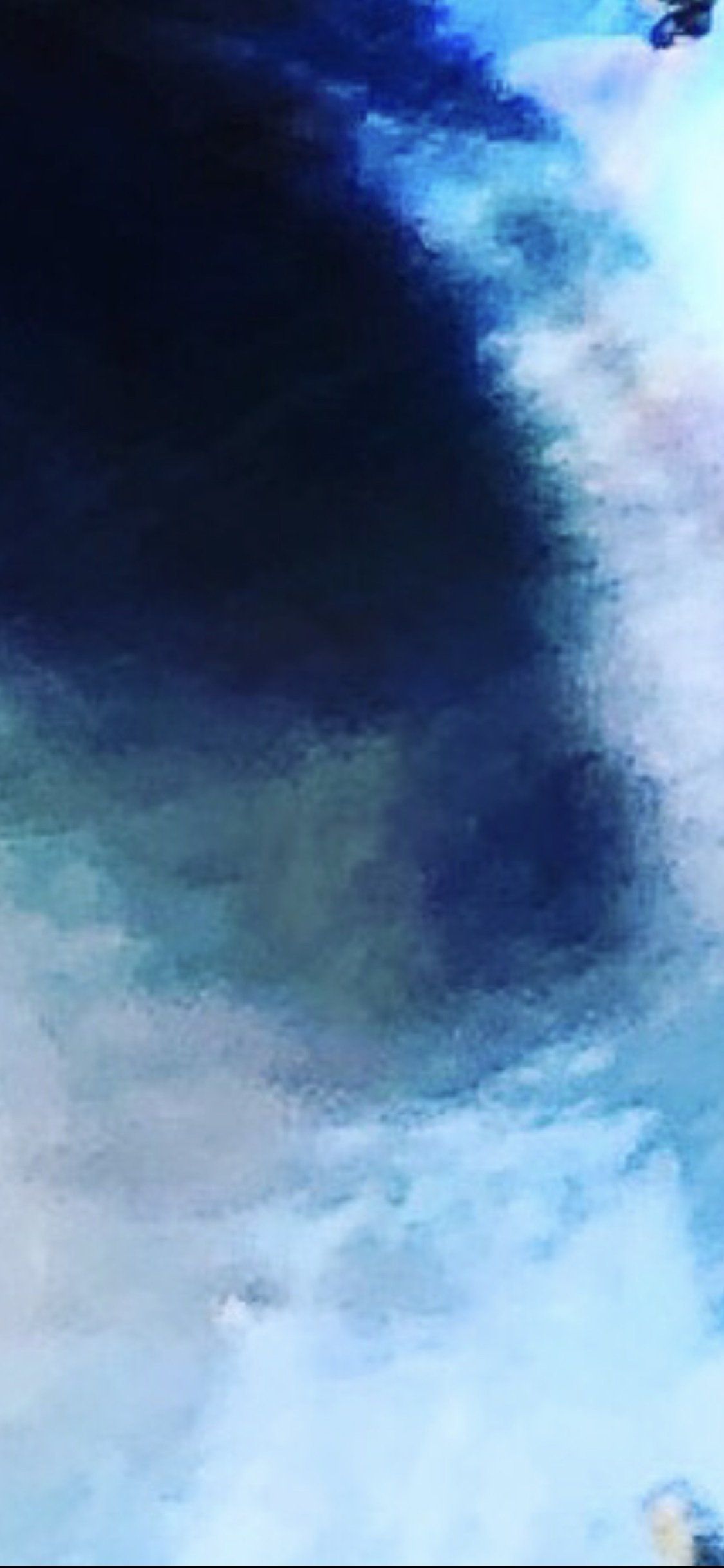 A close up of a blue and white painting on a wall.