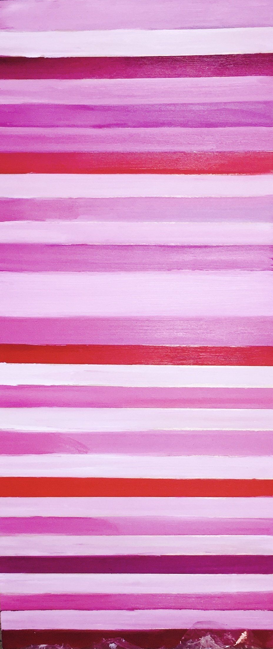 A close up of a pink and red striped background.