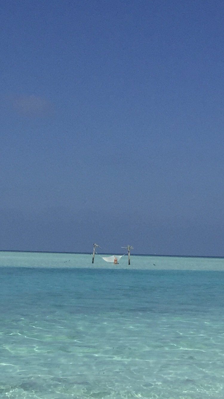 A boat is floating on top of a large body of water.