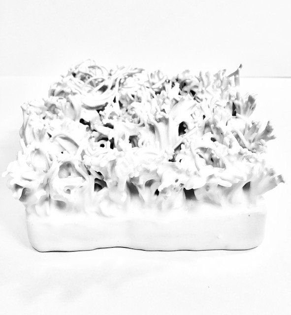 A black and white photo of a white sculpture on a white surface.