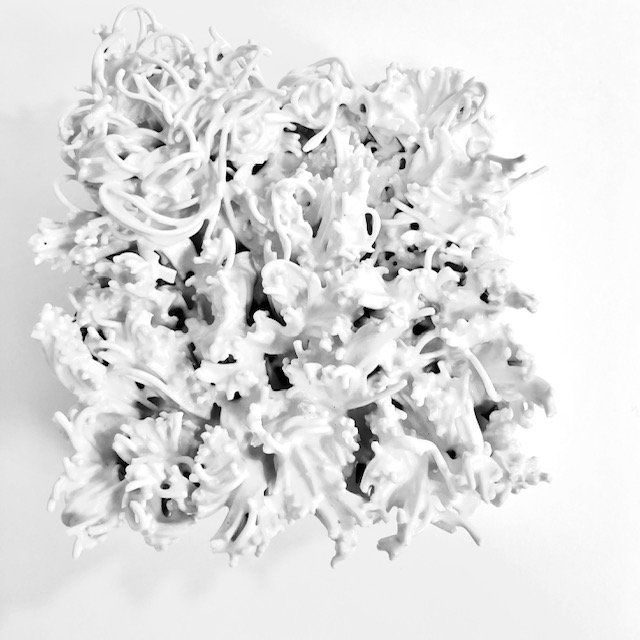 A pile of white shredded paper on a white surface