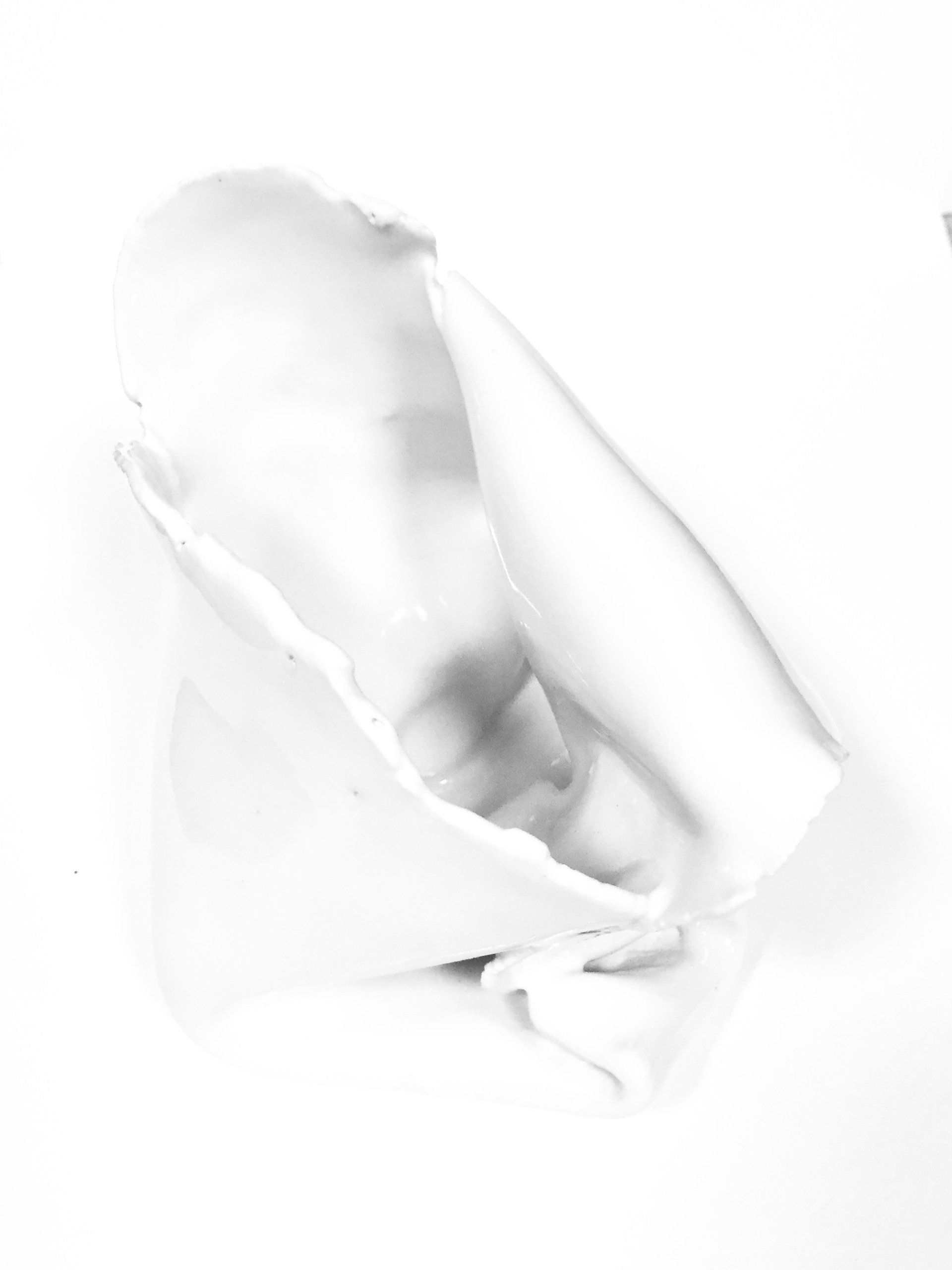 A black and white photo of a person holding a white object.