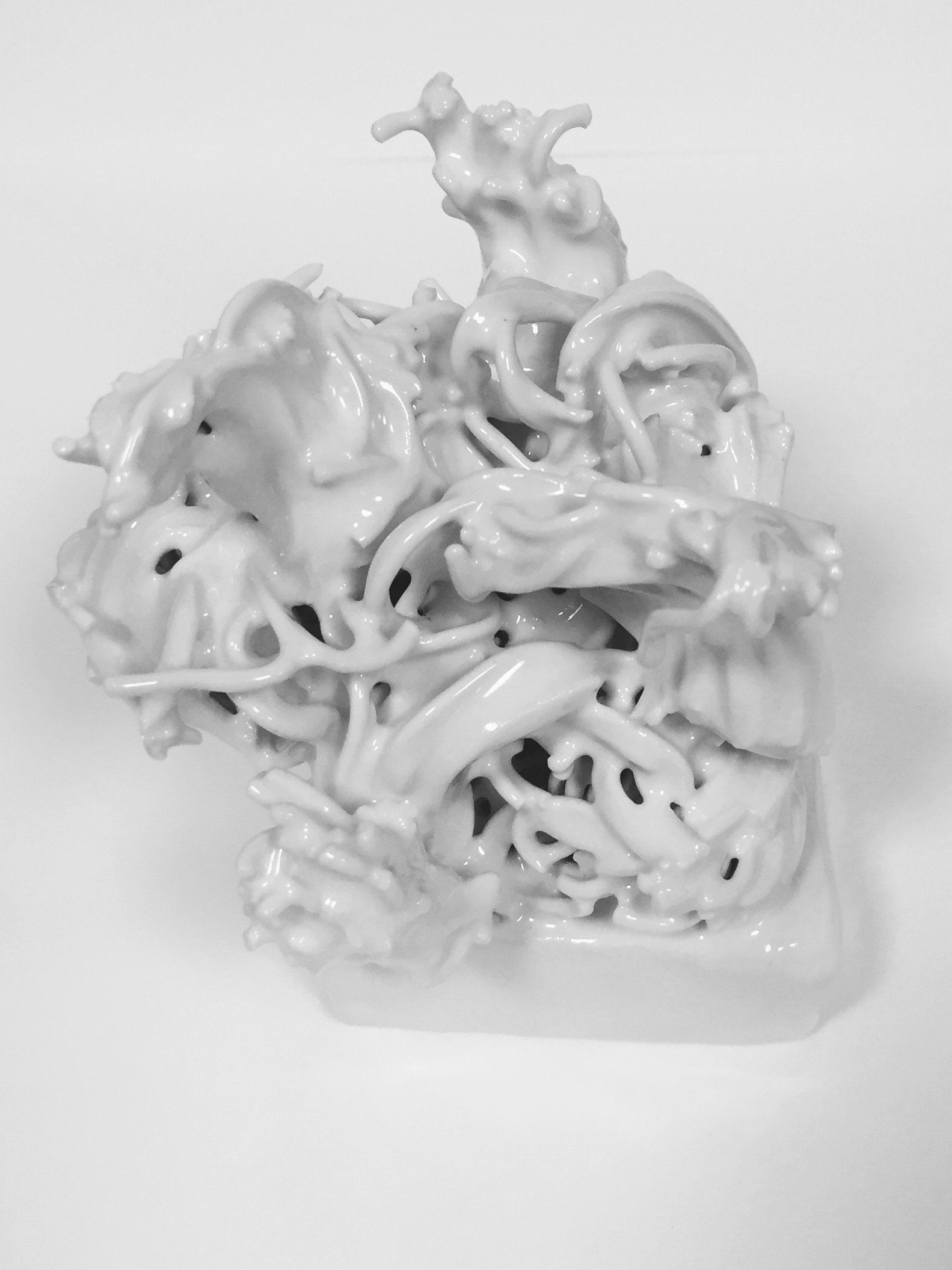 A black and white photo of a white sculpture on a white surface.