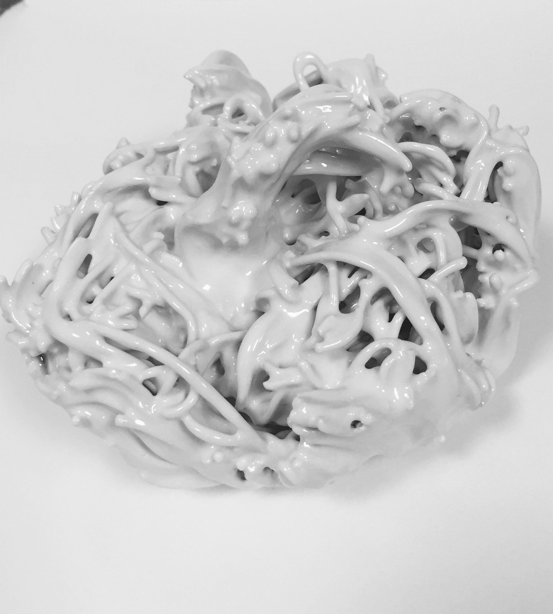A black and white photo of a pile of white noodles on a white plate.