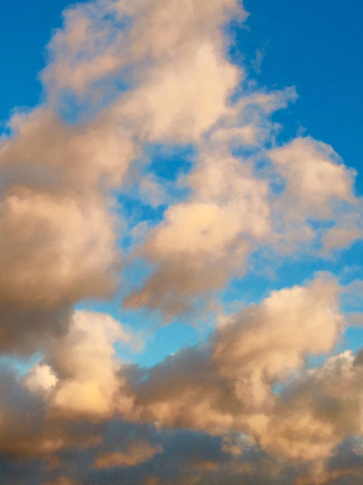 A blue sky with white clouds in it