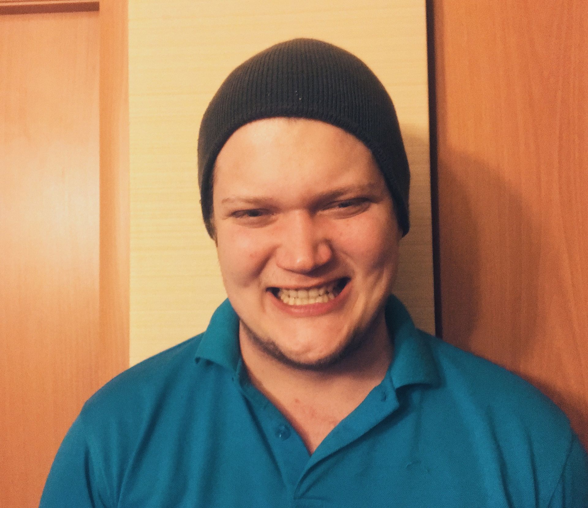 A woman and two children wearing crowns are sitting on a couch.