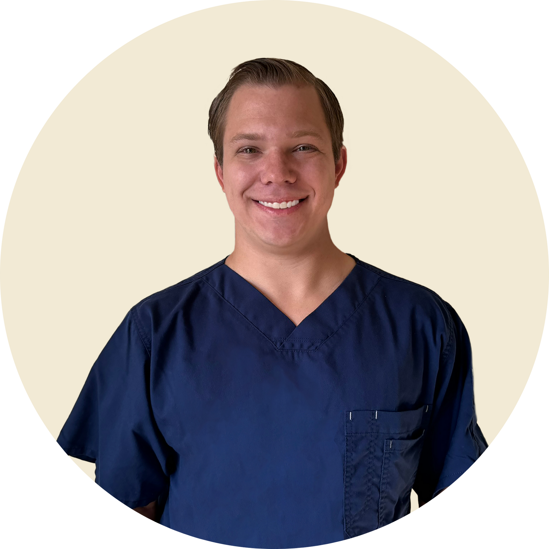 A woman in a green sweater is standing next to a tree.