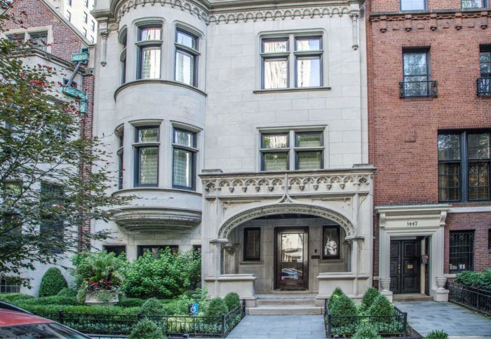 A large building with a lot of windows and a car parked in front of it