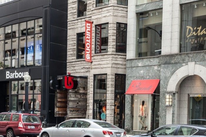 A car is parked in front of a burton store