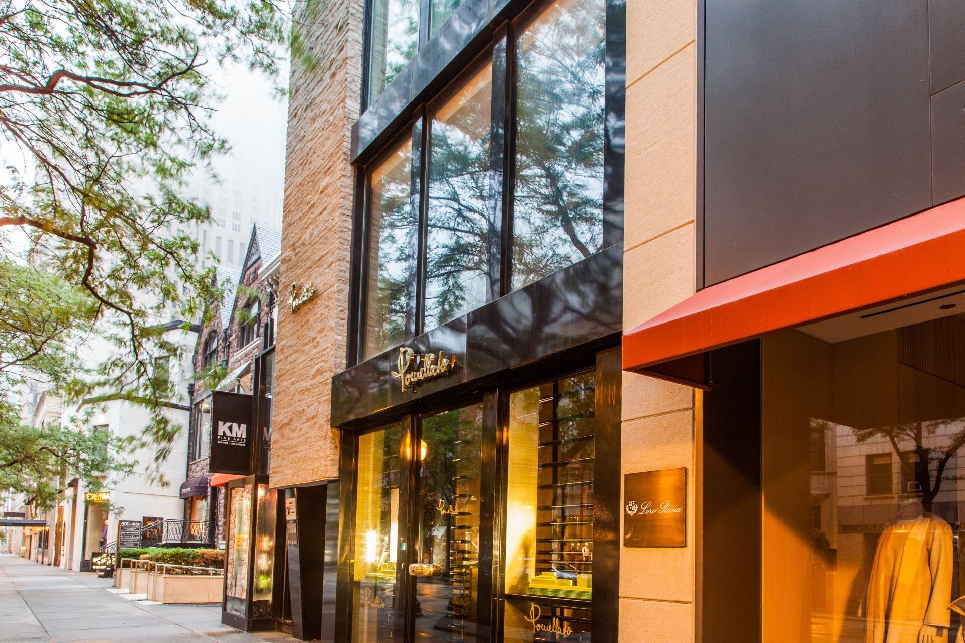 A building with a lot of windows and a red awning on the side of it.