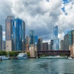 A panoramic view of a city skyline from across a body of water.