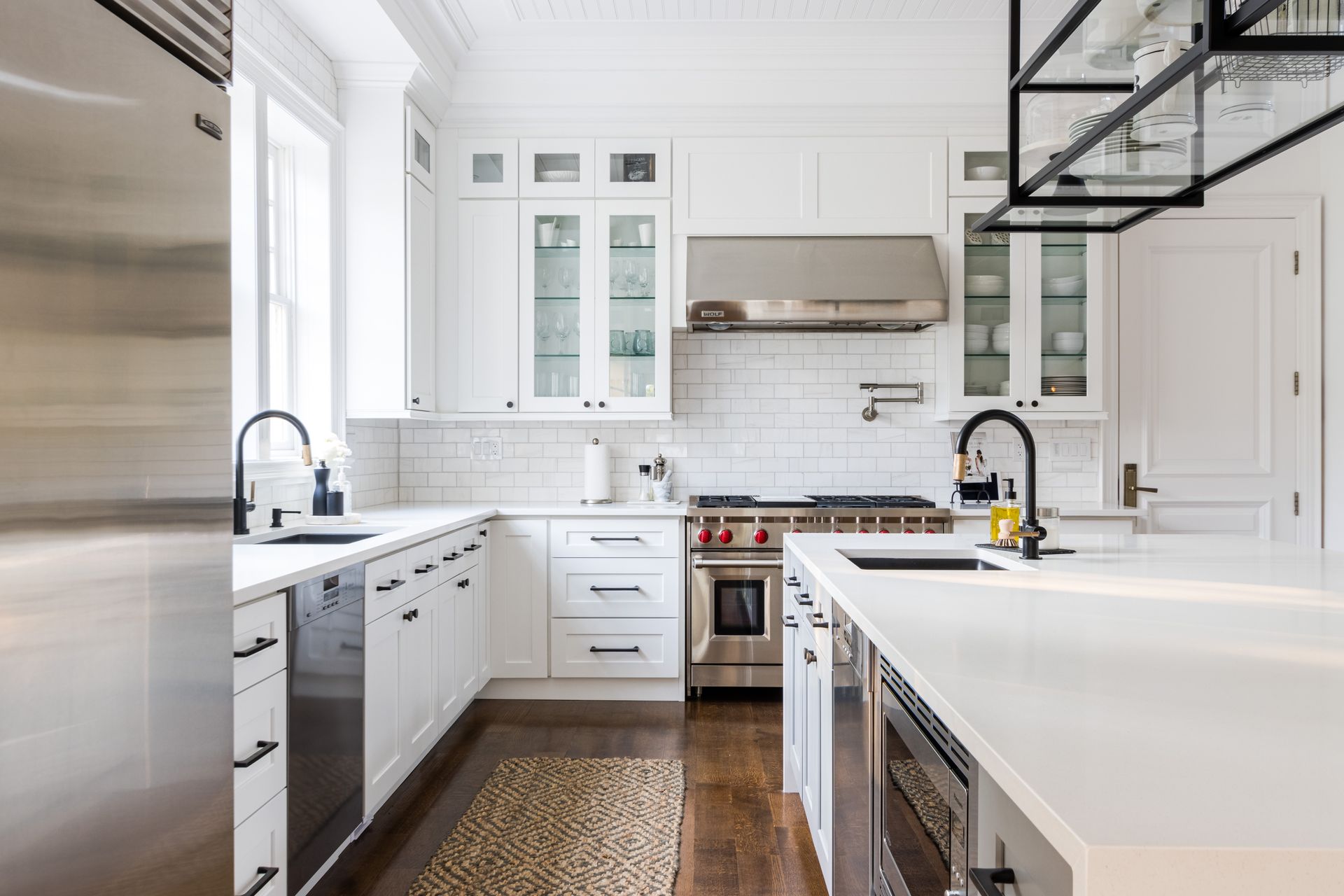 White kitchen with stainless steel appliances, white cabinets, and a kitchen island.