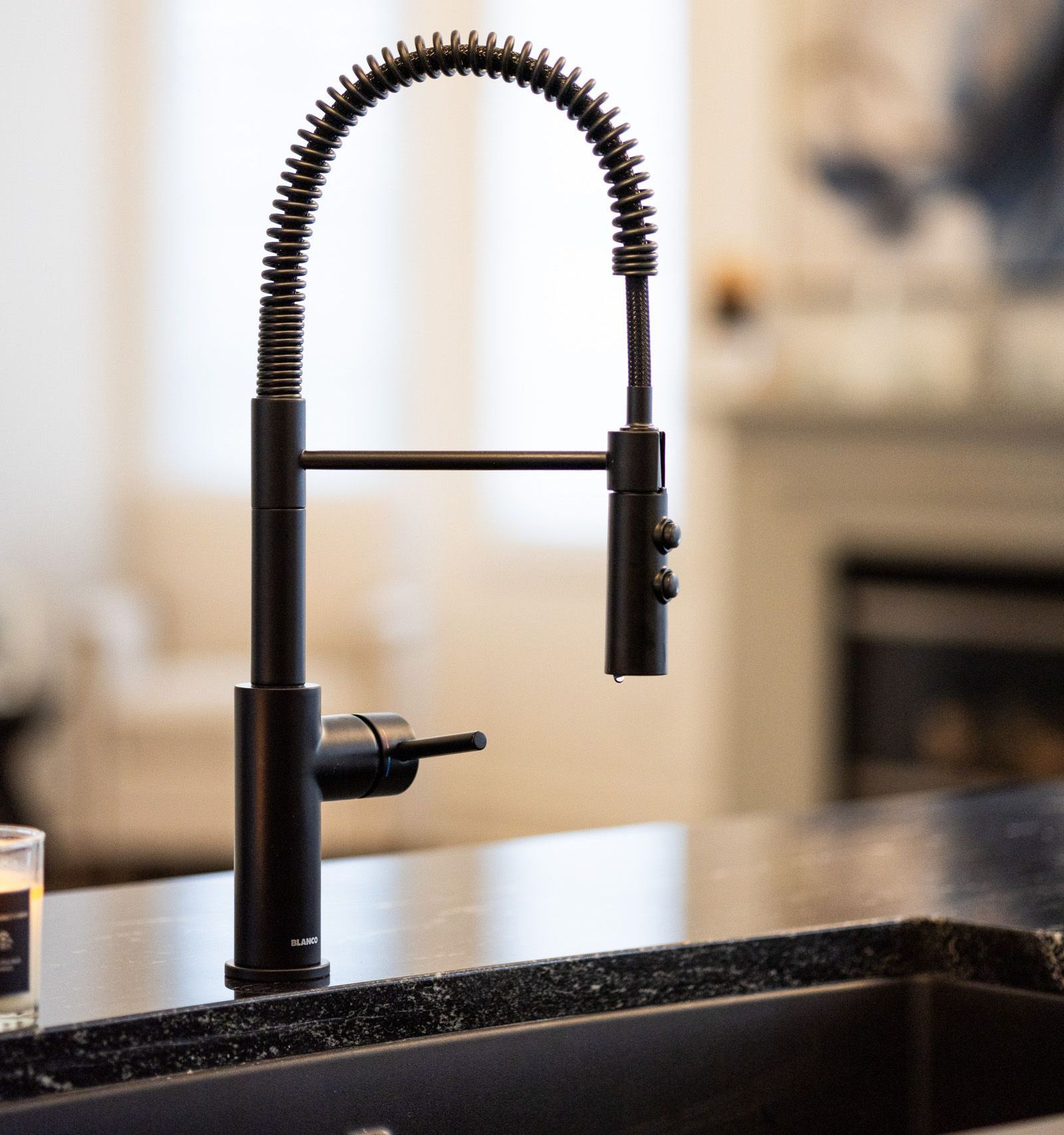 A kitchen sink with a black faucet on it