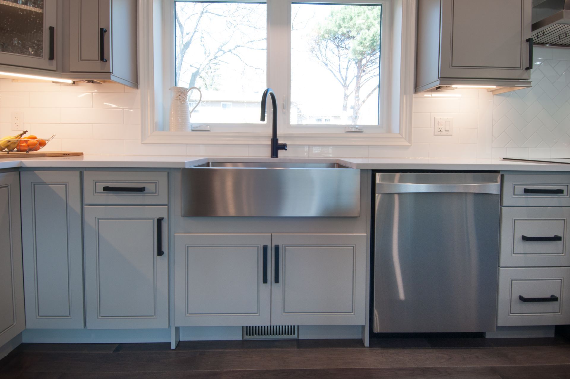 A kitchen with a stainless steel sink and a stainless steel dishwasher.