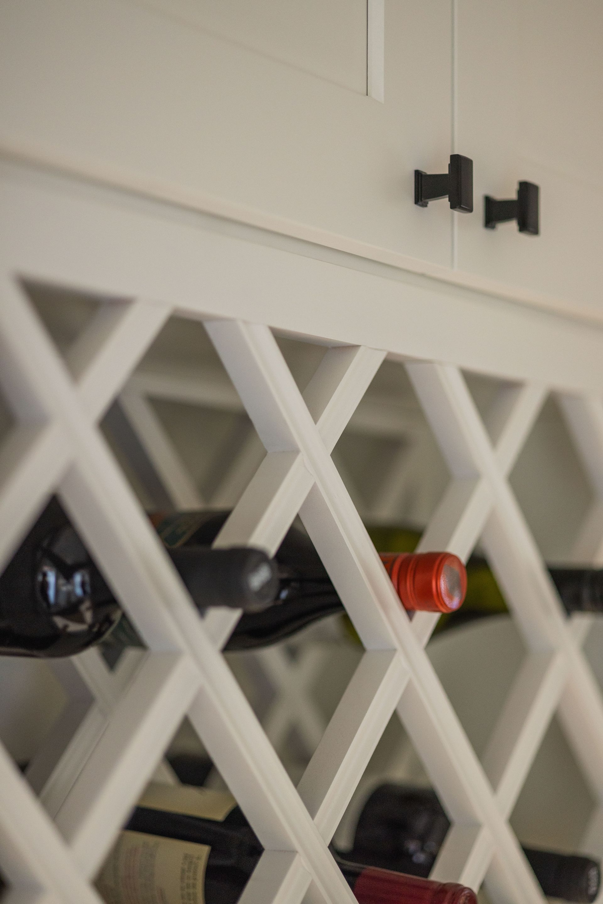 A wine rack filled with bottles of wine in a kitchen.