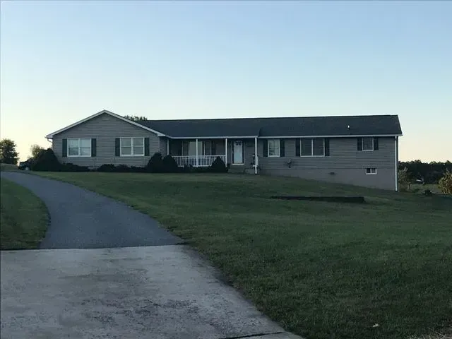 A large house with a driveway leading to it
