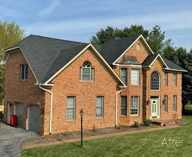 A large brick house with a black roof