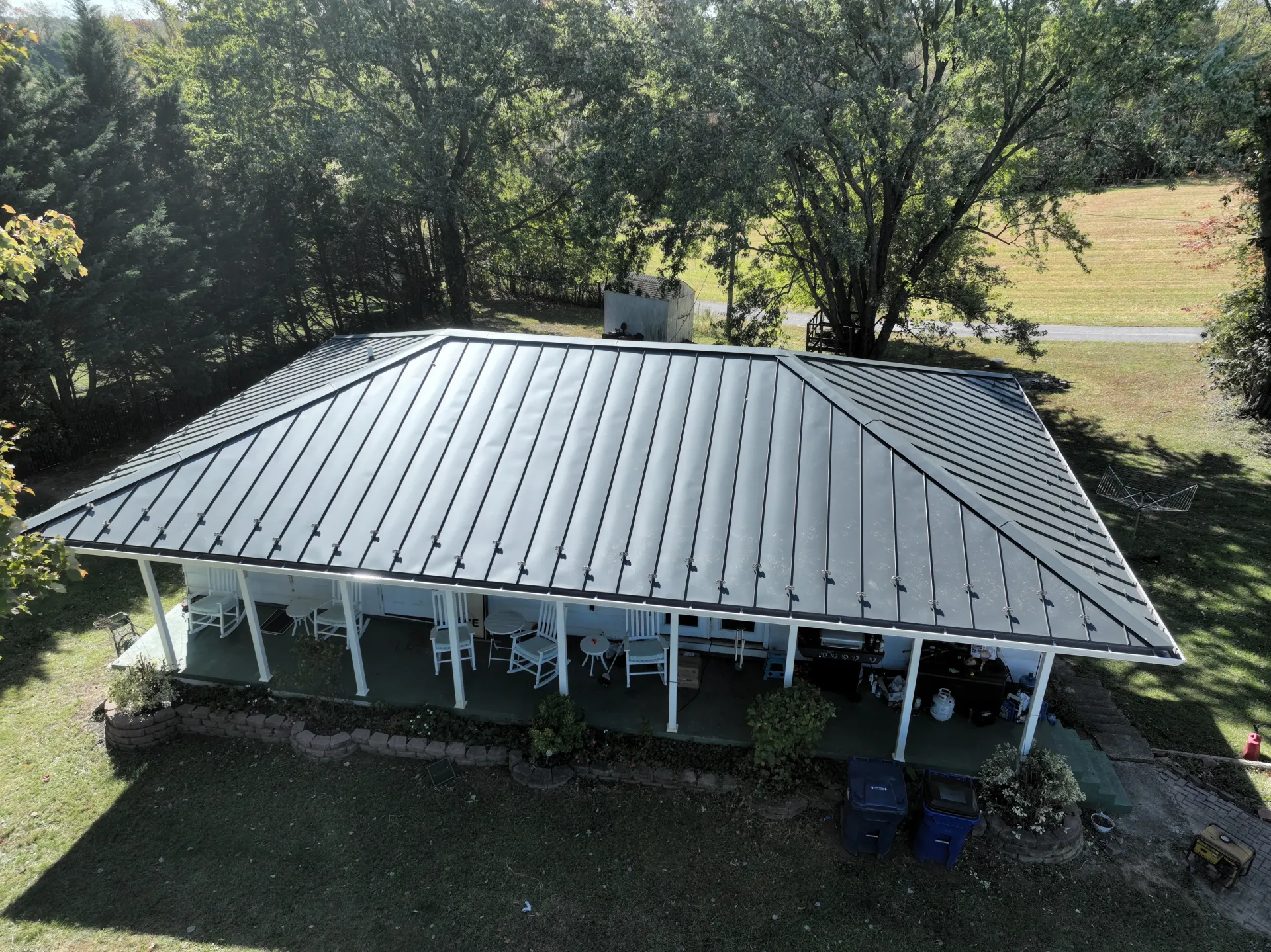 An aerial view of a house with a metal roof