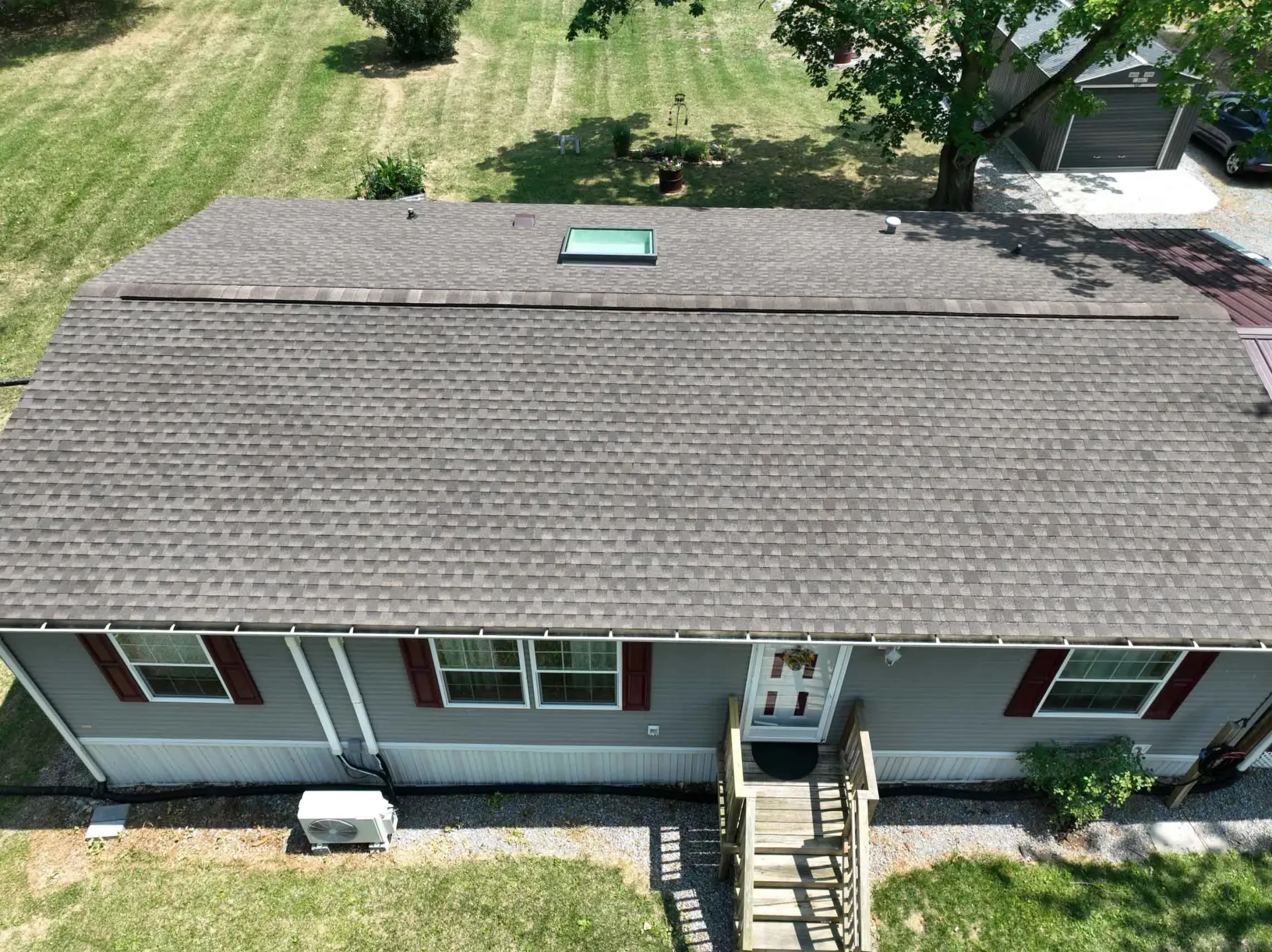 An aerial view of a house with a new roof.