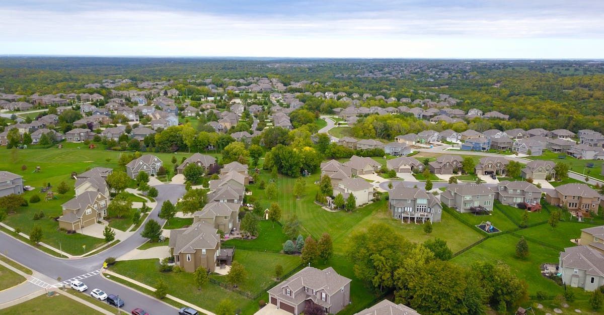 An aerial view of a residential neighborhood with lots of houses and trees.