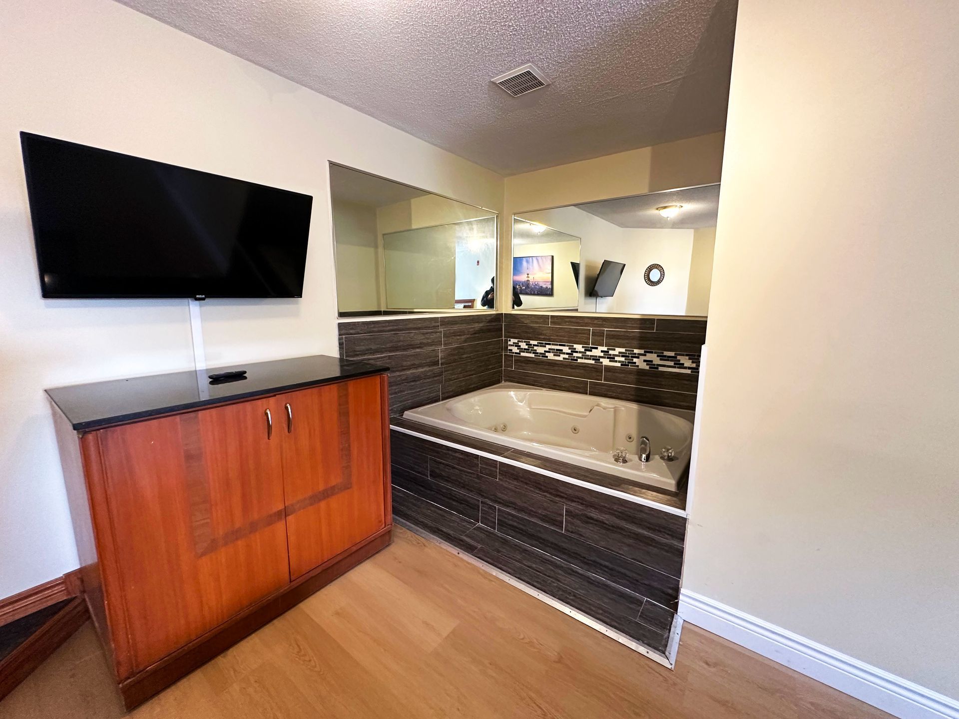 a bathroom with a jacuzzi tub and a flat screen tv