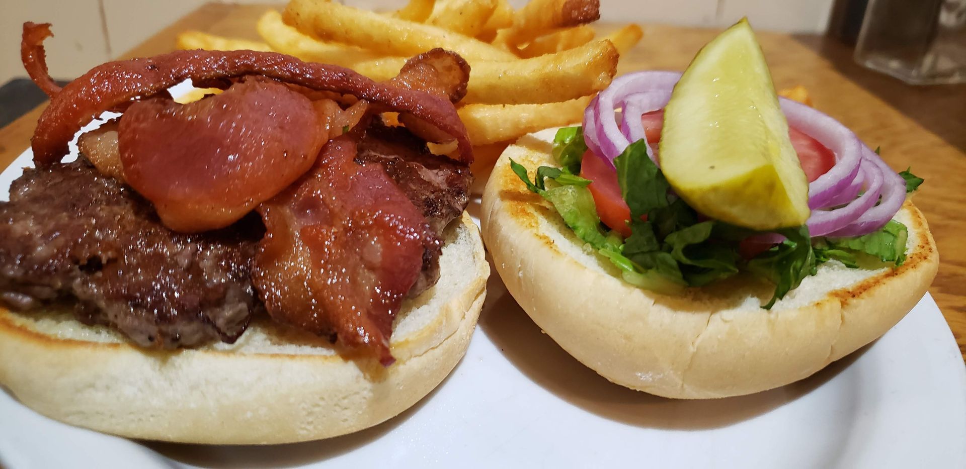 a hamburger and french fries on a white plate .