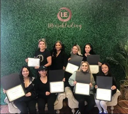 A group of women are posing for a picture while holding certificates.