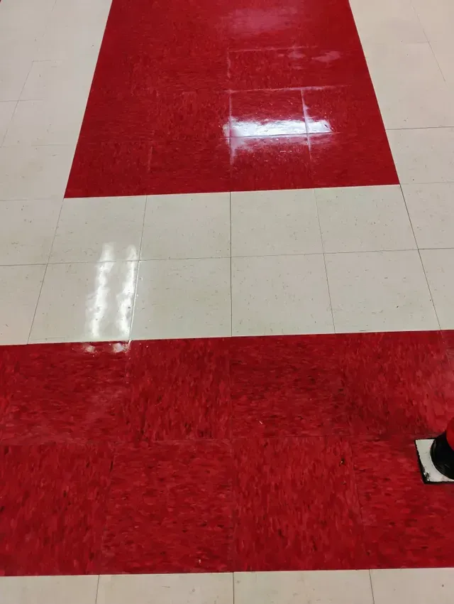 Red and white tiled floor with a shiny surface.