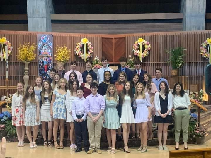 A group of young people are posing for a picture in a church.