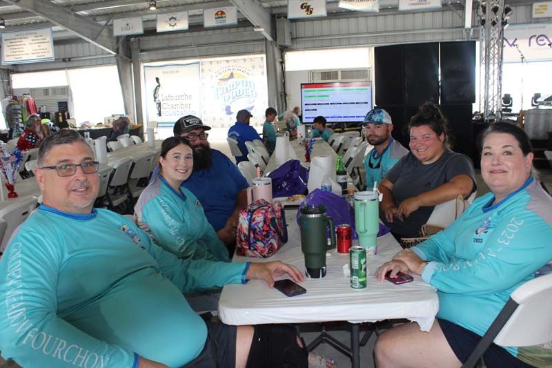 A group of people are sitting at a table in a room.
