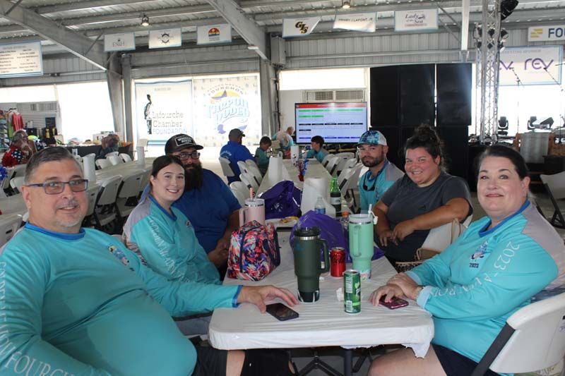 A group of people are sitting at a table in a room.